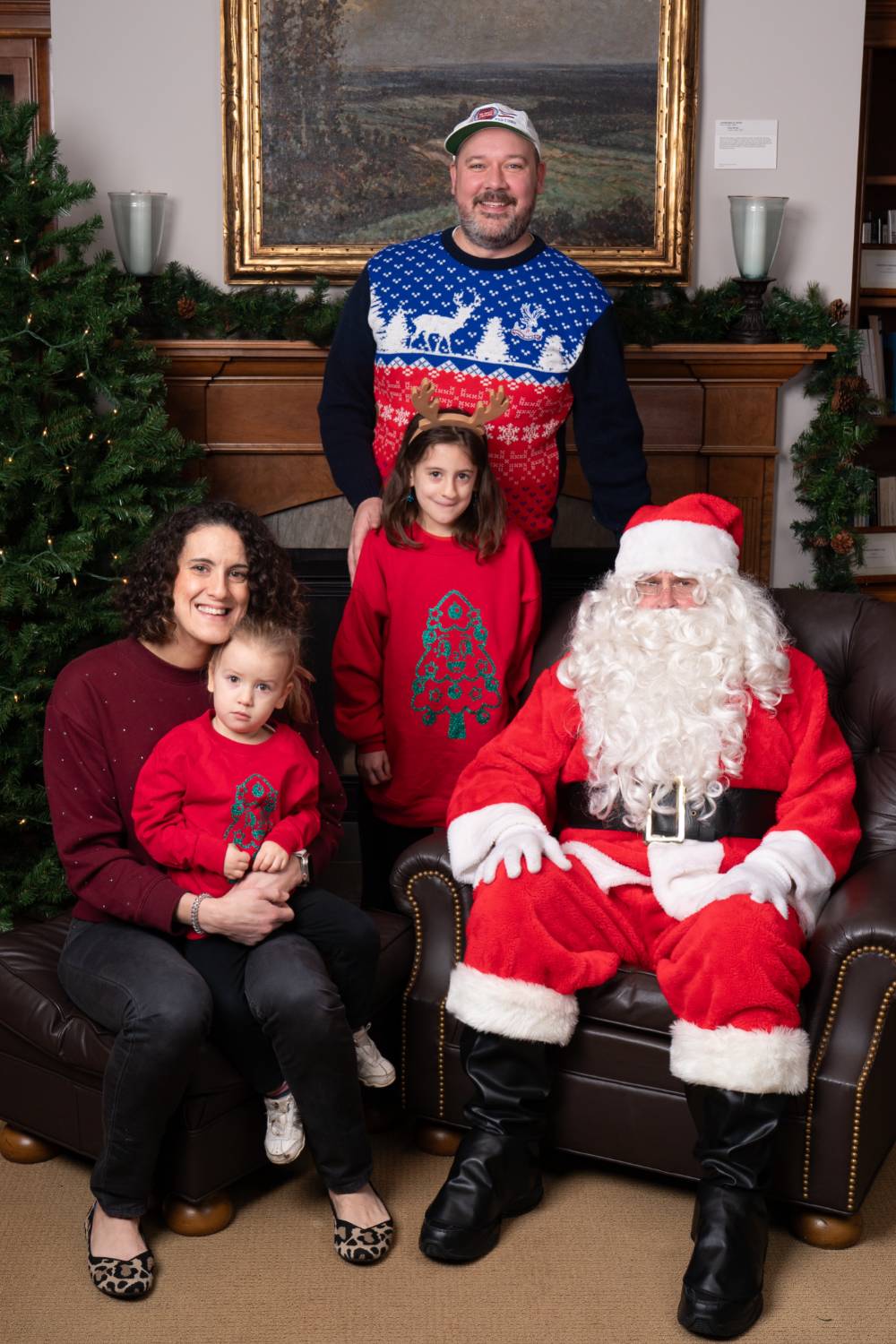 Family of four with Santa at the event.
